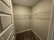Walk-in closet with neutral carpet and installed wire shelving rods at 1268 Newton St, Avon, IN 46123