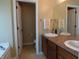 Bathroom features a double sink vanity with a large mirror and tiled flooring at 12866 Thames Dr, Fishers, IN 46037