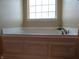 Close up view of white bathtub with paneling and chrome fixtures at 12866 Thames Dr, Fishers, IN 46037