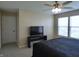 Spacious bedroom with a ceiling fan, plush carpeting and a large window for natural light at 12866 Thames Dr, Fishers, IN 46037