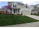 Well-maintained two-story home with manicured lawn, two car garage and an inviting covered entryway at 12866 Thames Dr, Fishers, IN 46037