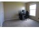 Home office space with a large window for natural light and a neutral carpet at 12866 Thames Dr, Fishers, IN 46037