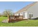 Charming back deck overlooking a lush green yard and landscaped flower beds at 13351 Grosbeak Ct, Carmel, IN 46033