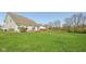 Expansive backyard with a lush green lawn, complemented by a wooden deck, offering ample space for outdoor activities at 13351 Grosbeak Ct, Carmel, IN 46033