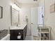 Well-lit bathroom with a single sink vanity, framed mirror, and tile flooring at 13351 Grosbeak Ct, Carmel, IN 46033