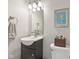 Cozy bathroom with a dark wood vanity, a gray towel, and a decorative framed picture at 13351 Grosbeak Ct, Carmel, IN 46033