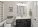 Traditional bathroom with a single sink vanity, framed mirror, and toilet at 13351 Grosbeak Ct, Carmel, IN 46033
