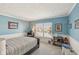 Well lit bedroom with blue walls and a comfortable bed with natural light from a window at 13351 Grosbeak Ct, Carmel, IN 46033