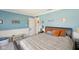 Cozy bedroom featuring blue accent walls, and a queen bed with comfortable bedding at 13351 Grosbeak Ct, Carmel, IN 46033