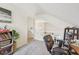 Bright bonus room showing stairs, carpeted floors, and natural lighting at 13351 Grosbeak Ct, Carmel, IN 46033