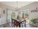Cozy dining room with wood table, backyard view, and access to outdoor deck, perfect for entertaining at 13351 Grosbeak Ct, Carmel, IN 46033