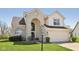 Traditional two-story home with brick facade, attached garage, well-maintained lawn, and blue sky background at 13351 Grosbeak Ct, Carmel, IN 46033