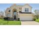 Traditional two-story home featuring a brick facade, attached two-car garage and a well-maintained lawn at 13351 Grosbeak Ct, Carmel, IN 46033