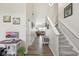 Bright hallway with hardwood floors leading to an open-concept living area and staircase at 13351 Grosbeak Ct, Carmel, IN 46033