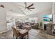 Open-concept living room with a cozy sofa, fireplace, and seamless transition to the dining area at 13351 Grosbeak Ct, Carmel, IN 46033