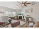 Comfortable living room with vaulted ceiling, fan, fireplace, sofa, and large window with natural light at 13351 Grosbeak Ct, Carmel, IN 46033