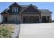 Two-story home featuring mixed siding and a large concrete driveway at 1426 Redwood Dr, Crawfordsville, IN 47933