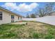 Large, enclosed backyard with a small concrete patio, grass area, and a white privacy fence at 1463 Rebecca Ln, Franklin, IN 46131