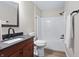 Bathroom with wood-look flooring, vanity with granite countertop, framed mirror, and a shower-tub combo at 1463 Rebecca Ln, Franklin, IN 46131
