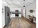 Bright kitchen with stainless steel appliances, white cabinetry, and stylish lighting at 1463 Rebecca Ln, Franklin, IN 46131