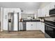 Modern kitchen with white cabinetry, stainless steel appliances, and dark countertops for a sleek, contemporary feel at 1463 Rebecca Ln, Franklin, IN 46131