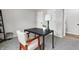 Home office featuring neutral walls, carpeted floor, and a modern black desk complemented by a white desk lamp at 1463 Rebecca Ln, Franklin, IN 46131