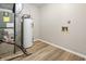 A well-lit utility room with modern flooring and essential appliances, neatly organized for convenience at 1463 Rebecca Ln, Franklin, IN 46131