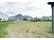Large grassy backyard featuring a swing set and view of neighboring homes at 15702 Cobbs Crk Ln, Noblesville, IN 46060