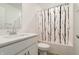 Bathroom with modern sink, toilet, and shower with stylish curtain at 15702 Cobbs Crk Ln, Noblesville, IN 46060