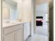 Bright bathroom features double sinks, quartz counters, walk-in shower and doorway to bedroom at 15702 Cobbs Crk Ln, Noblesville, IN 46060