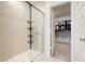 Bright bathroom features a glass enclosed walk-in shower and doorway to the walk-in closet at 15702 Cobbs Crk Ln, Noblesville, IN 46060