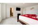 A bedroom with a tv, doorway to the walk-in closet, and doorway to the bathroom at 15702 Cobbs Crk Ln, Noblesville, IN 46060