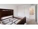 Bright bedroom featuring a dark wood bed frame and a window at 15702 Cobbs Crk Ln, Noblesville, IN 46060