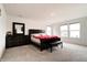 Spacious bedroom featuring neutral carpet, windows, a dark wood dresser and a queen-size bed at 15702 Cobbs Crk Ln, Noblesville, IN 46060