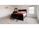 Bright bedroom features neutral carpet, a dark wood dresser, queen bed and a window at 15702 Cobbs Crk Ln, Noblesville, IN 46060