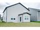 Exterior view of home featuring light gray siding and manicured lawn at 15702 Cobbs Crk Ln, Noblesville, IN 46060