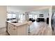 Open-concept kitchen with bar top seating, seamlessly flowing into the dining and living areas at 15702 Cobbs Crk Ln, Noblesville, IN 46060