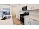 Bright kitchen featuring stainless steel appliances, quartz countertops and white cabinetry at 15702 Cobbs Crk Ln, Noblesville, IN 46060