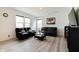 Living room featuring modern floors, and two black leather sofas, and natural light from windows at 15702 Cobbs Crk Ln, Noblesville, IN 46060