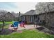 Lovely backyard featuring a brick patio with a fire pit and outdoor seating, surrounded by green grass at 16 Corkwood Ct, Brownsburg, IN 46112