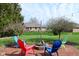 Charming backyard with a brick patio, fire pit, and colorful Adirondack chairs, perfect for outdoor entertaining at 16 Corkwood Ct, Brownsburg, IN 46112