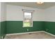 This bedroom has green accent paint and a window at 16 Corkwood Ct, Brownsburg, IN 46112