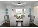 Elegant dining area with large windows, stylish furnishings, and a modern light fixture at 16 Corkwood Ct, Brownsburg, IN 46112