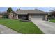 A single-Gathering home with a brick facade, well-kept lawn, and attached two-car garage at 16 Corkwood Ct, Brownsburg, IN 46112