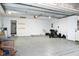 Spacious garage features a durable epoxy floor, ample storage space and access to a side entry door at 16 Corkwood Ct, Brownsburg, IN 46112