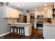 Updated kitchen with stainless steel appliances, stylish backsplash, and convenient bar stool seating at 16 Corkwood Ct, Brownsburg, IN 46112