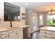 Modern kitchen featuring stainless steel dishwasher, sleek white cabinets, and a mosaic backsplash at 16 Corkwood Ct, Brownsburg, IN 46112