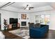 Bright living room featuring a fireplace, large window, stylish furniture, and hardwood floors at 16 Corkwood Ct, Brownsburg, IN 46112