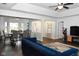 Open-concept living room featuring hardwood floors, a ceiling fan, and ample natural light at 16 Corkwood Ct, Brownsburg, IN 46112