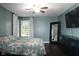 This main bedroom has blue walls, hardwood floors, and a ceiling fan at 16 Corkwood Ct, Brownsburg, IN 46112